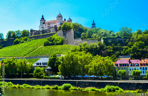 The mighty fortress Marienberg is the symbol of Wurzburg. Festung Marienberg rises above the River Main and vineyards on the hillside.  Germany,