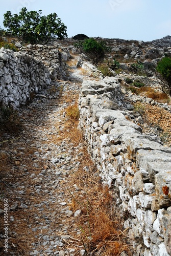 Greece, Karpathos island, rural street, stone pathway on the way to Vroukounta village. photo