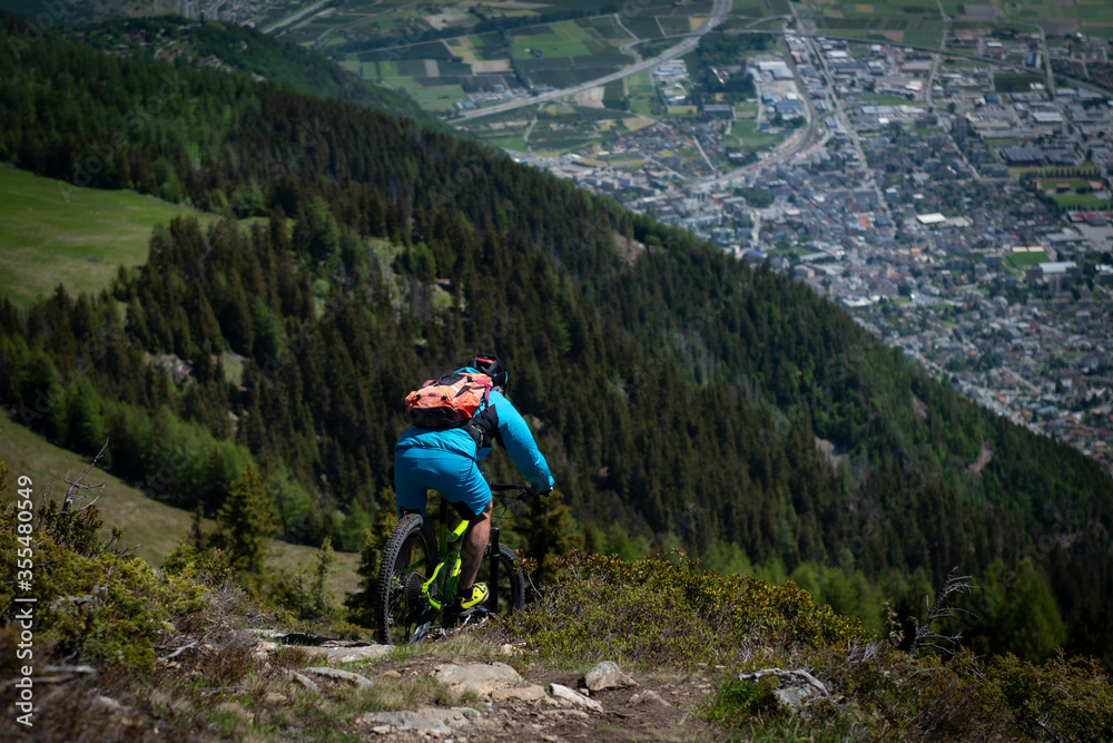 Mountainbiker slides down the mountain.