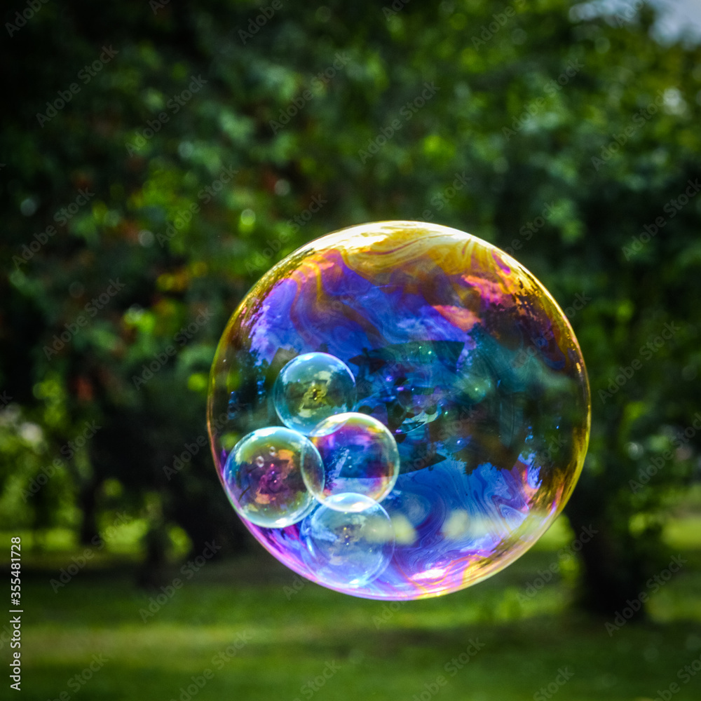 Soap bubble with smaller bubbles inside close up Soap bubble with smaller bubbles inside close up