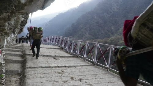 pilgrim getting carried in a basket on the route of kedarnath  photo