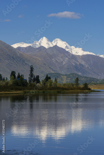 The mount  Belukha   is reflected in the waters of the lake Yazevoe.  Altay  Kazakhstan 