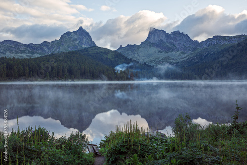  Mount Ergaki early in the morning in the fog, in the foreground Lake Svetloye.