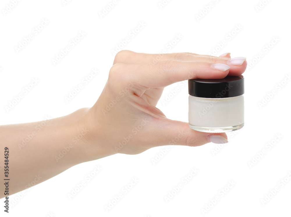Cosmetic glass jar with coconut oil in hand on white background isolation Cosmetic glass jar with coconut oil in hand on white background isolation