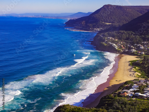 Panoramic view of Stanwell Park Beach Sydney Australia on a sunny winters day blue skies waves on the sand photo