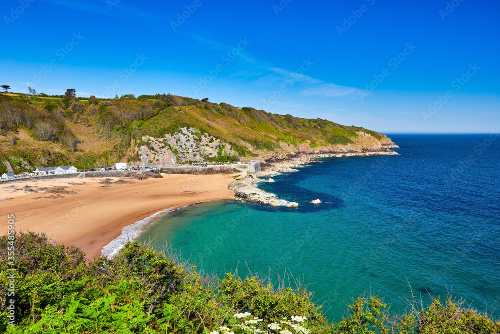 Image of La Greve de Lecq in the mornig sumer sunshine at low tide with sandy beach and clear water. Jersey, Channel Islands, Uk