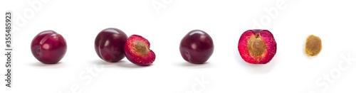 A set of sliced purple plums. Close up. Isolated on a white background