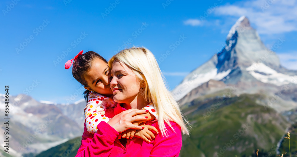 Mother and daughter on top of a mountain. The concept of travel, lifestyle Mother and daughter on top of a mountain. The concept of travel, lifestyle