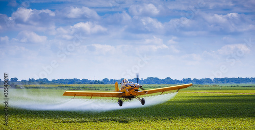 Yellow Crop Duster Airplane Aerially Applies Pesticide to Cotton Fields in Texas