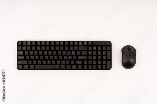 black plastic keyboard and mouse on white background. selective focus. photo