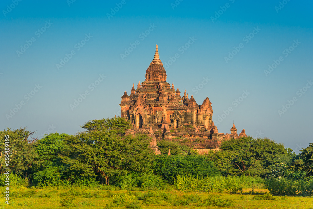 View of a Majestic Ancient Temple in Bagan, Myanmar. Cloudy beautiful Sky, Copy Space. Archaeological Park with beautiful Pagodas