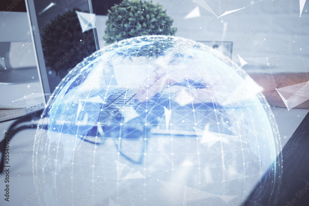 Double exposure of businessman working on laptop on background. International business hologram in front. Concept of success. Double exposure of businessman working on laptop on background. International business hologram in front. Concept of success.