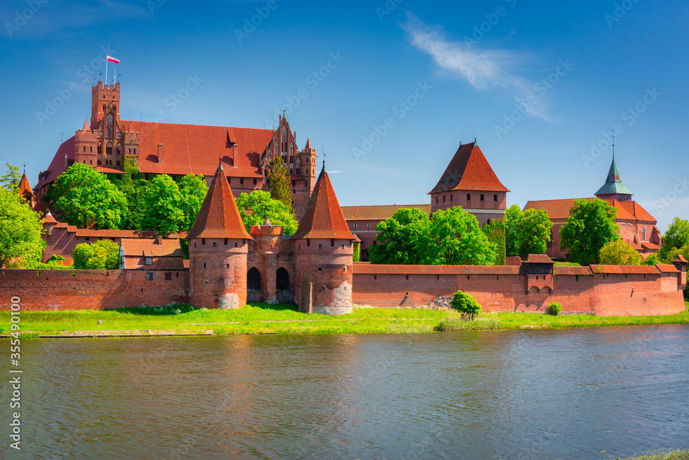 Malbork castle by the Nogat river at summer, Poland