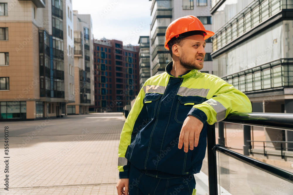 a clean builder shows sincere emotions of indignation. Man in special clothes and helmet shows hostility a clean builder shows sincere emotions of indignation. Man in special clothes and helmet shows hostility