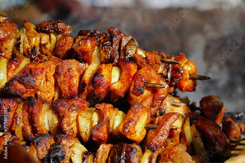 Food at the festival of street food in Krakow/Cracow, Poland. Grilled meat and vegetables. Shashlik or shashlyk is a dish of skewered and grilled cubes of meat.