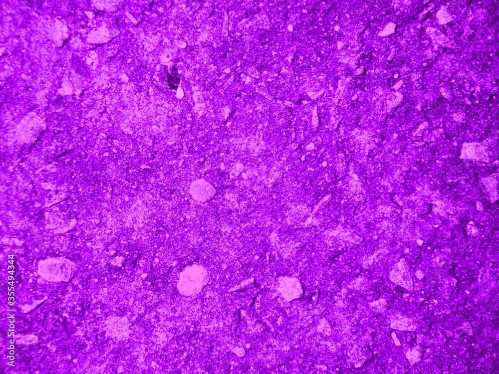 abstract purple background. natural uneven violet background. texture of painted cement with small stones