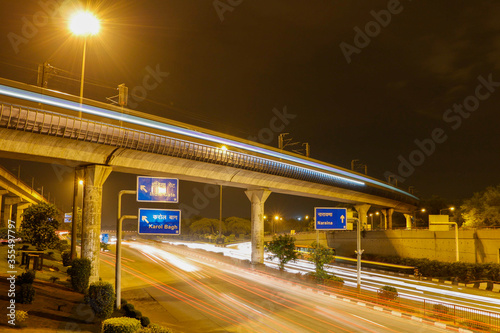Light trail of the Delhi Metro Rail passing over Dhaula Kuan ring road.