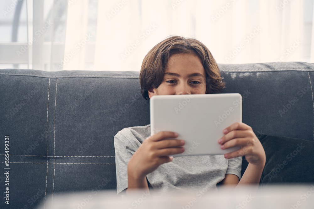 Smiling Caucasian child sitting on the sofa Smiling Caucasian child sitting on the sofa