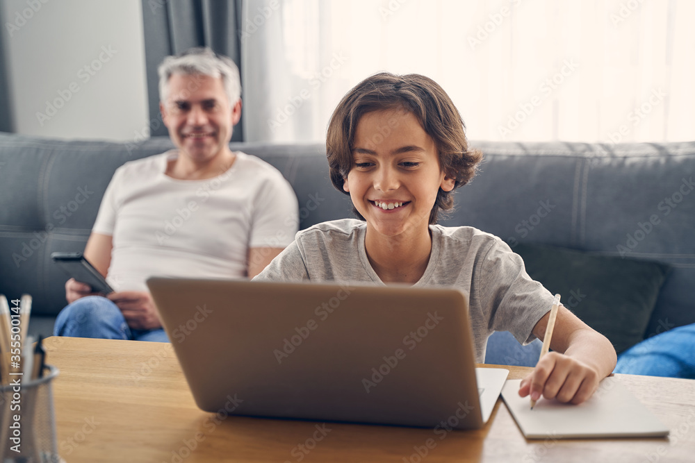 Two family members sitting and smiling sincerely Two family members sitting and smiling sincerely