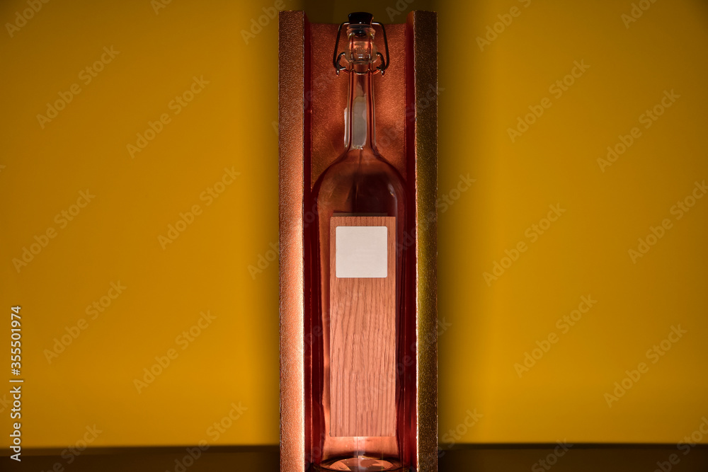 presentation of old glass bottle and unbranded wood