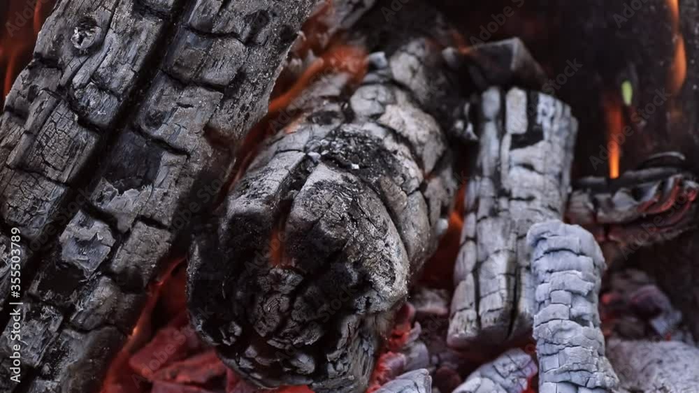 closeup of the coals burning inside of a barbecue grill closeup of the coals burning inside of a barbecue grill