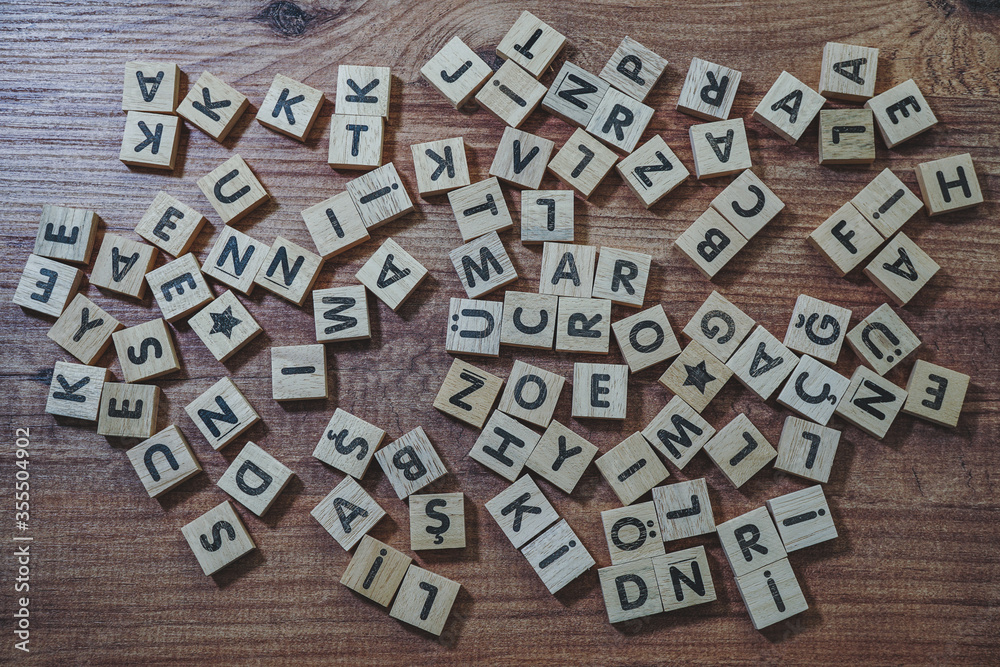 alphabets wooden cubes, wooden background table, view from above.