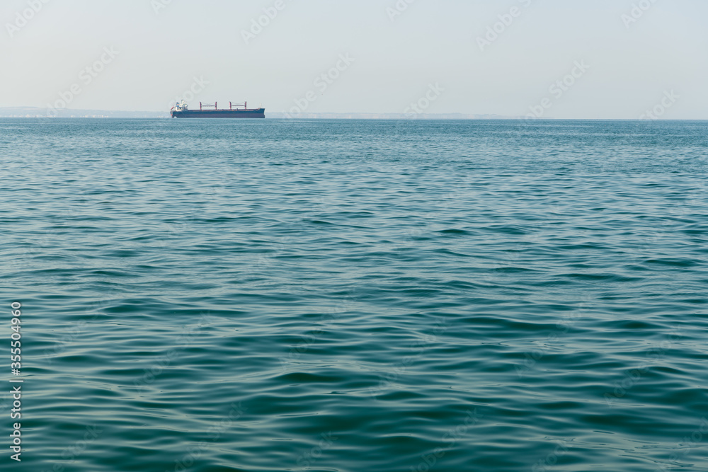 Aegian Sea win a ship on the background in Thessaloniki, Greece