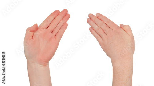 Freckled white hand. Isolated woman's hand palm up and palm down, fingers together and wrist bent in a gesture indicating direction, or waving