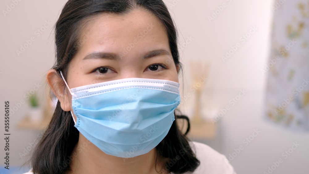 Portrait of an Asia young female who is wearing a face shield with mask rounded around her face from a frontal perspective to protect her glasses and eyes prepare to new normal. Coronavirus pandemic.