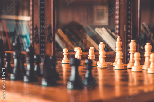 Wallpaper Mural Close up chess pieces on board game. Wooden vintage shelf book background Torontodigital.ca