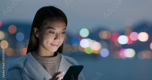 Canvas Print Woman use of smart phone at night