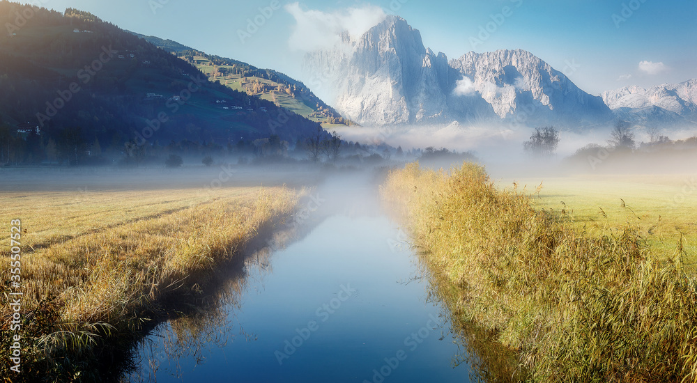 Wonderful picturesque Scene. Amazing Misty Morning. Beautiful nature Scenery. scenic view of Majestic Mountain Peak with river foreground, shoot in morning in Autumn season, Fantastic Alpine Landscape