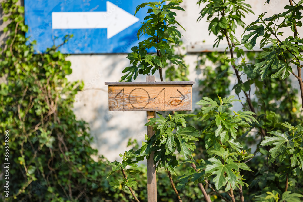 View of wooden board with number 101 and arrow shows direction to home View of wooden board with number 101 and arrow shows direction to home