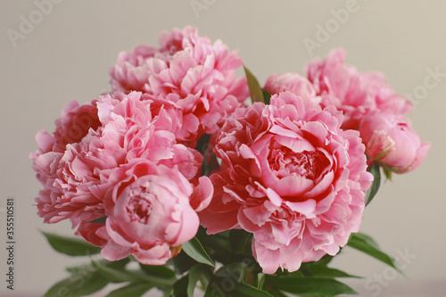 Flowers composition. Pink peony flowers on wooden background. Mothers day. Flat lay, top view.