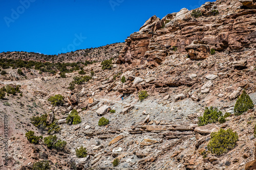 woman hiking alone in desert canyon