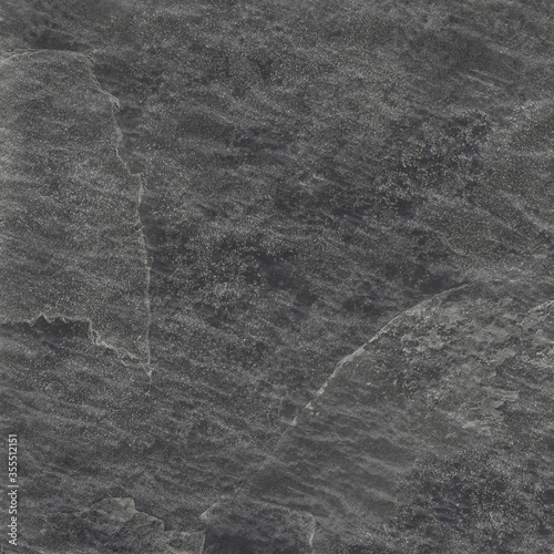 Natural stone texture. Rough black granite surface backgroung. Travertine flooring