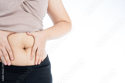 Fat woman holding excessive fat belly, overweight fatty belly isolated on over white background. Diet lifestyle, weight loss, stomach muscle, healthy concept.
