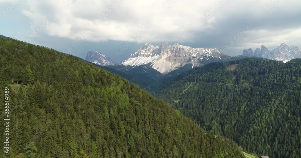 Flying low over trees toward beautiful mountain in the Dolomites, Aerial Alps Flying low over trees toward beautiful mountain in the Dolomites, Aerial Alps