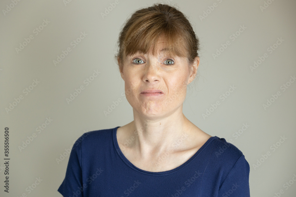 Middle aged woman making funny face in studio Middle aged woman making funny face in studio