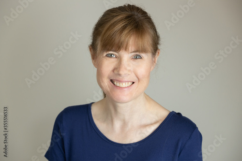 Portrait of smiling middle aged woman in studio © Sharon