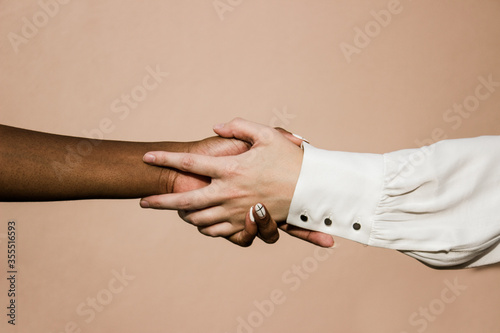 Black and white person holding hands