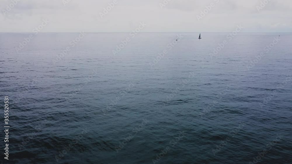 Drone flight over the sea. Clouds and a boat in the horizon in Caldes d'Estrach, Spain, Europe.. Drone flight over the sea. Clouds and a boat in the horizon in Caldes d'Estrach, Spain, Europe..