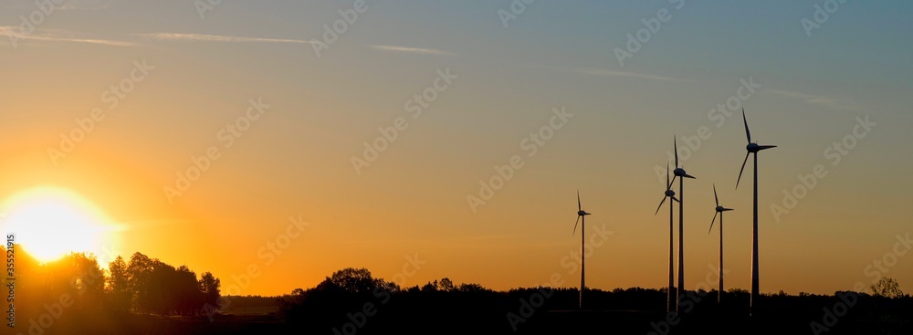  Field of wind generators at sunset. Great sun on the horizon.