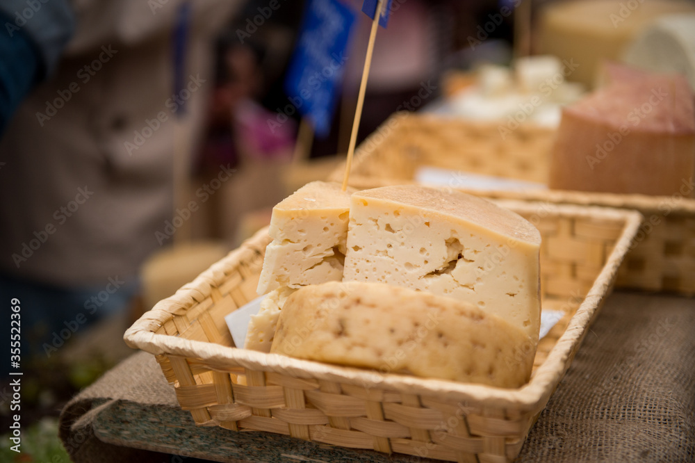 Heads of cheese. Hard cheese. Cheese. Cheese Festival. Craft cheese. A piece of hard cheese. 