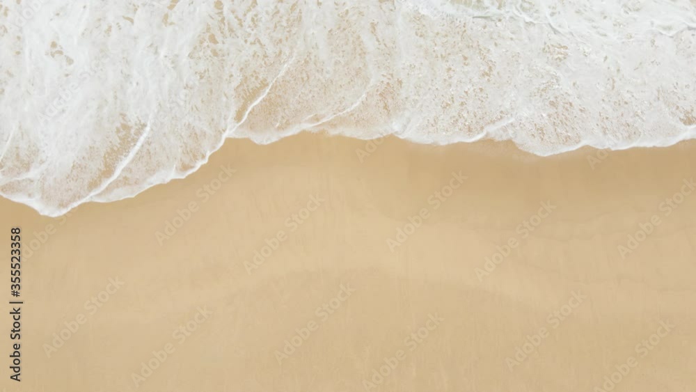 4K UHD aerial drone view top view waves crashing empty beach from above. Areal drone view moving beach.