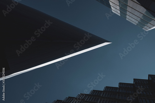 Abstract background. View through modern architecture upwards to blue sky  - abstract architecture detail background in turquoise teal blue.