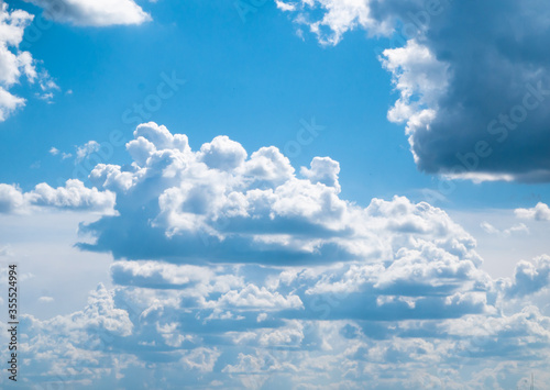 Large white clouds with a flat bottom floating in a bright blue sky
