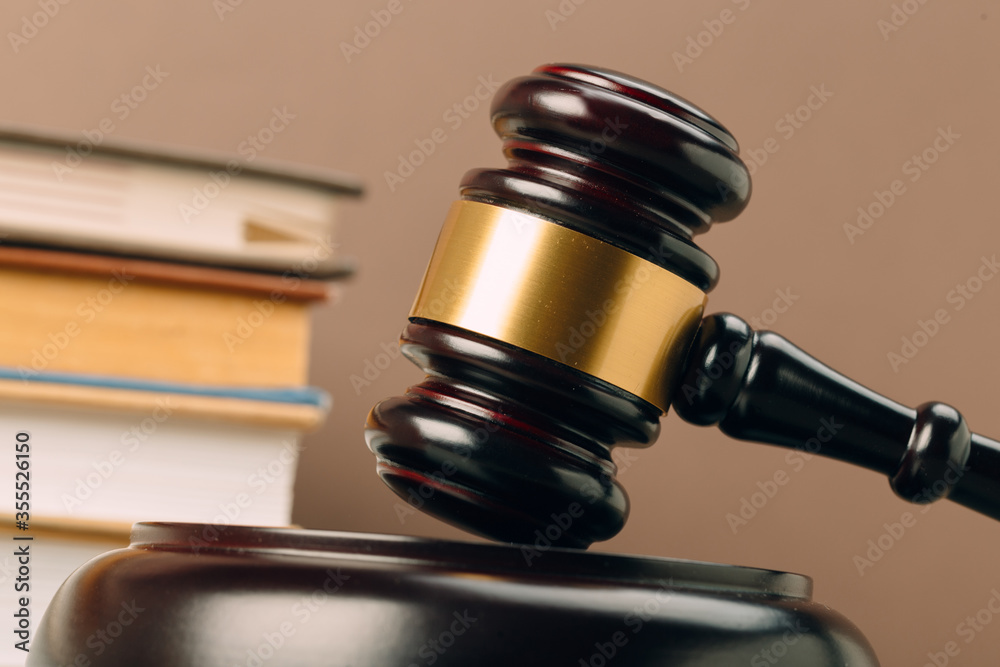 Judge gavel and laws books on a wooden table. Judge gavel and laws books on a wooden table.