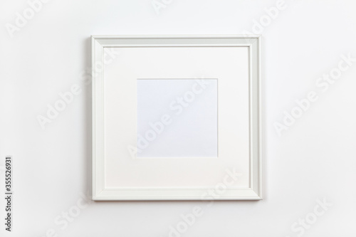 White clean square frame with passepartout on white background, copy space. Flat lay or side view, minimal style mock-up. For gift shop, social media, website design.