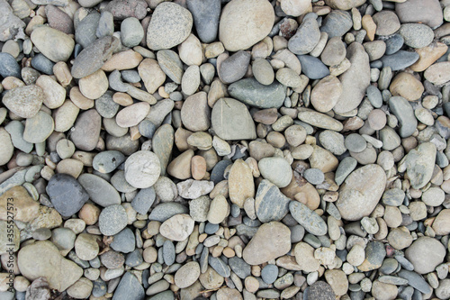 Background of gravel. Rocky riverbank. The texture of the rocky shore. Background for an inscription.